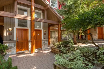 a front door of a house with a tree at Symphony by Whistler Premier in Whistler