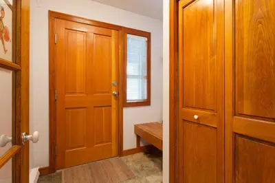 a hallway with a wooden door and a window at Treeline Townhome by Whistler Premier in Whistler