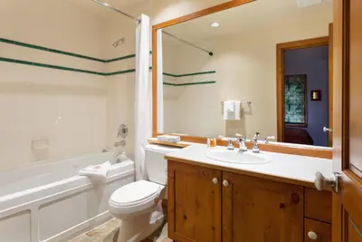 a bathroom with a toilet and a tub and a sink at Treeline Townhome by Whistler Premier in Whistler