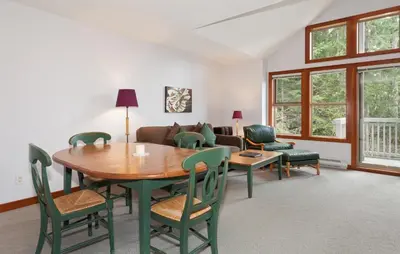 a living room with a table and chairs and a couch at Treeline Townhome by Whistler Premier in Whistler