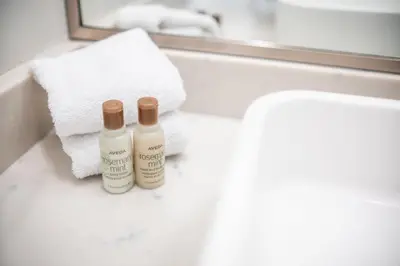 two bottles of soap sitting on a counter in a bathroom at The Woods by Outpost Whistler in Whistler