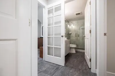 a white bathroom with a toilet and a shower at The Woods by Outpost Whistler in Whistler
