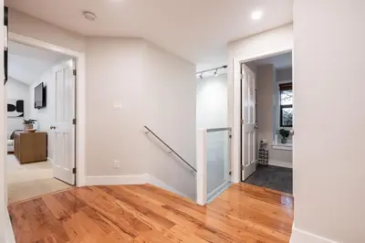 an empty hallway with white walls and wood floors at The Woods by Outpost Whistler in Whistler