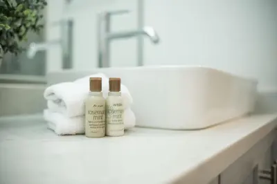 two bottles of soap and towels on a bathroom counter at The Woods by Outpost Whistler in Whistler