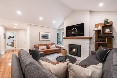 a living room with a couch and a fireplace at The Woods by Outpost Whistler in Whistler