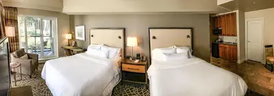 a hotel room with two beds with white sheets at Fairways Hotel on the Mountain in Victoria