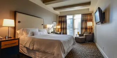 a hotel room with a bed and a window at Fairways Hotel on the Mountain in Victoria