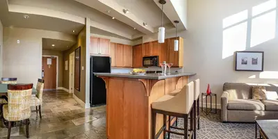 a kitchen with a bar and a living room at Fairways Hotel on the Mountain in Victoria