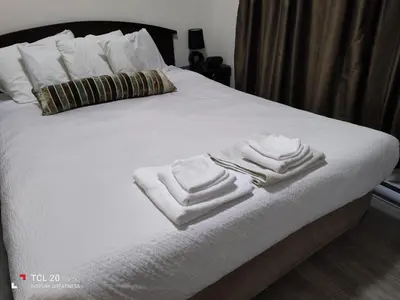 a bed with white towels on top of it at Sweet House B&B in Victoria