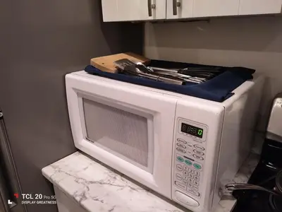 a white microwave oven sitting on top of a counter at Sweet House B&B in Victoria