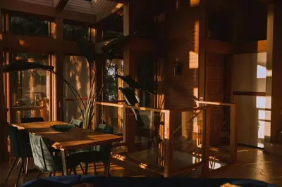 a dining room with a table and a window at The Sanctuary Retreat Salt Spring Island in Salt Spring Island