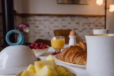 a table with a tea kettle and a plate of food at eARTh studios GallerySuite in Nelson