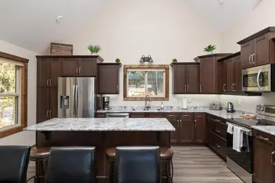 a kitchen with wooden cabinets and a marble counter top at Summit View in Valemount