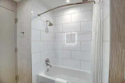 a white bathroom with a tub and a shower at Holiday Inn Express & Suites - Calgary Airport Trail NE by IHG in Calgary