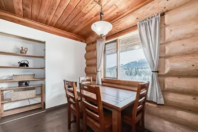 a dining room with a table and chairs and a window at Terracana Ranch Resort in Tete Jaune Cache