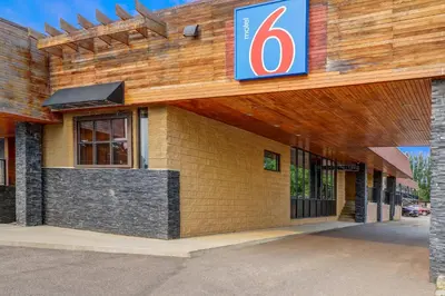 a building with a number six sign on it at Motel 6 Brooks AB in Brooks