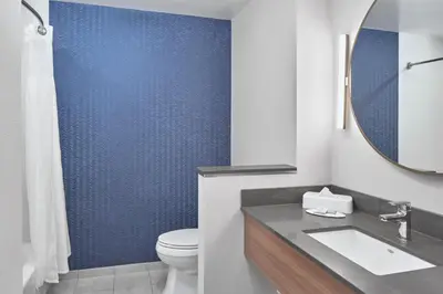 a bathroom with a toilet and a sink and a mirror at Fairfield Inn & Suites by Marriott Penticton in Penticton