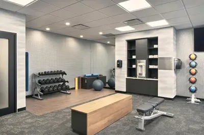 a fitness room with a gym with a bench and weights at Fairfield Inn & Suites by Marriott Penticton in Penticton