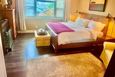 a bedroom with a large bed and a window at Corkscrew Willow Estate in Vancouver