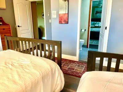 a bedroom with a bed and a bathroom at Corkscrew Willow Estate in Vancouver