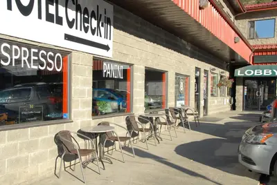 a row of tables and chairs outside of a store at Hotel Deoro in Lillooet