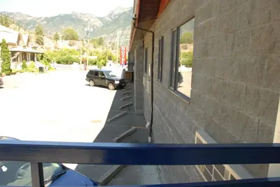a window of a building with a car in a parking lot at Hotel Deoro in Lillooet