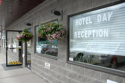 a store front with a white car in a window at Hotel Deoro in Lillooet