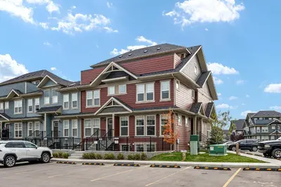 a house with a car parked in a parking lot at GlobalStay Cranbrook Townhome Suites in Calgary
