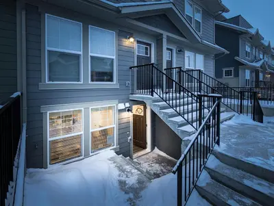 a house with a staircase leading to a door at GlobalStay Cranbrook Townhome Suites in Calgary