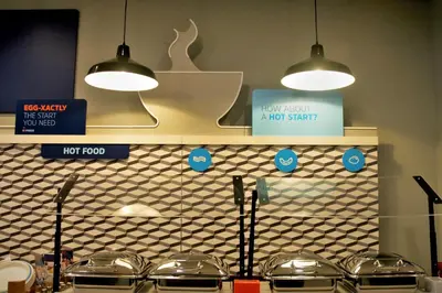 a kitchen with two lights hanging above a counter at Holiday Inn Express & Suites - Edmonton SW – Windermere by IHG in Edmonton