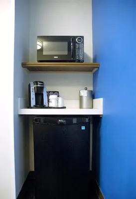 a kitchen with a microwave and a toaster oven on a shelf at Holiday Inn Express & Suites - Edmonton SW – Windermere by IHG in Edmonton