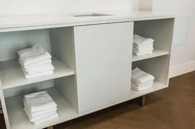a white counter with towels on shelves in a bathroom at Holiday Inn Express & Suites Edmonton N - St Albert by IHG in St. Albert