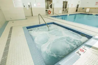a jacuzzi tub in a swimming pool at Holiday Inn Express & Suites Edmonton N - St Albert by IHG in St. Albert