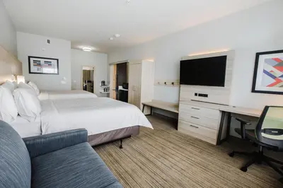 a hotel room with a bed and a desk with a tv at Holiday Inn Express & Suites Edmonton N - St Albert by IHG in St. Albert