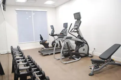 a row of exercise bikes in a gym with chairs at Holiday Inn Express & Suites Edmonton N - St Albert by IHG in St. Albert