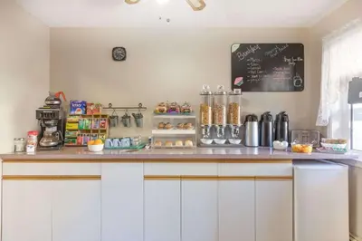 a kitchen with a counter with a chalkboard on the wall at Almada Inn in Fort Nelson