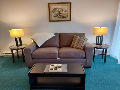 a living room with a couch and a coffee table at Richter Pass Beach Resort in Osoyoos