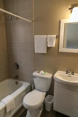 a bathroom with a toilet and a sink and a tub at Richter Pass Beach Resort in Osoyoos