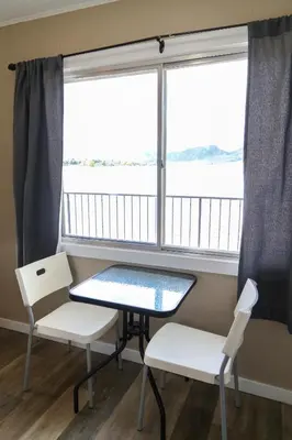 a table and two chairs in a room with a window at Richter Pass Beach Resort in Osoyoos
