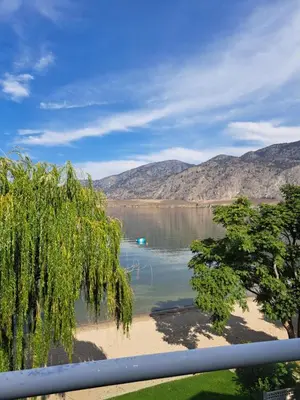 a view of a lake with a boat in the water at Richter Pass Beach Resort in Osoyoos