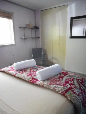 a bedroom with a bed with two pillows on it at Queen, walk to village center in Whitehorse