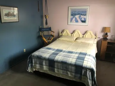 a bedroom with a bed with a plaid blanket at Queen, walk to village center in Whitehorse