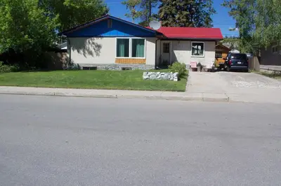 a small house with a red roof on a street at Nice Bunk Bed in Whitehorse