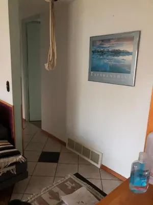 a room with a table and a picture on the wall at Nice Bunk Bed in Whitehorse