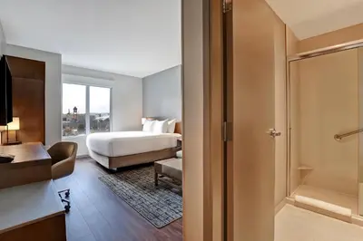 a hotel room with a bed and a window at Hyatt Place Prince George in Prince George