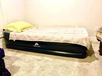 a bed in a room with a bed frame at Deluxe House in Surrey