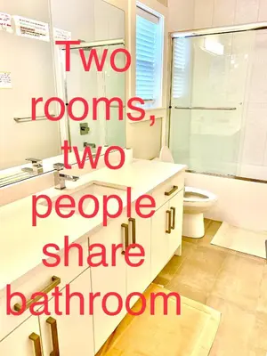 two rooms two people share a bathroom at Deluxe House in Surrey