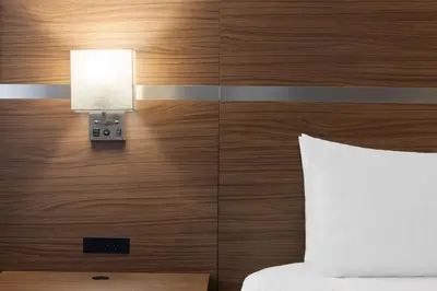 a hotel room with a bed and a light on a wall at Baymont by Wyndham Edson in Edson