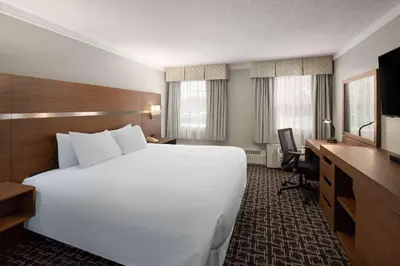 a large white bed in a hotel room at Baymont by Wyndham Edson in Edson