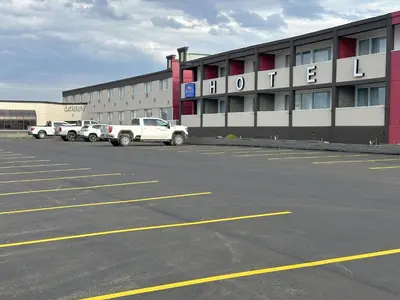 an empty parking lot in front of a hotel at Baymont by Wyndham Edson in Edson